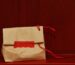 A bottle standing in a tall narrow gift bag