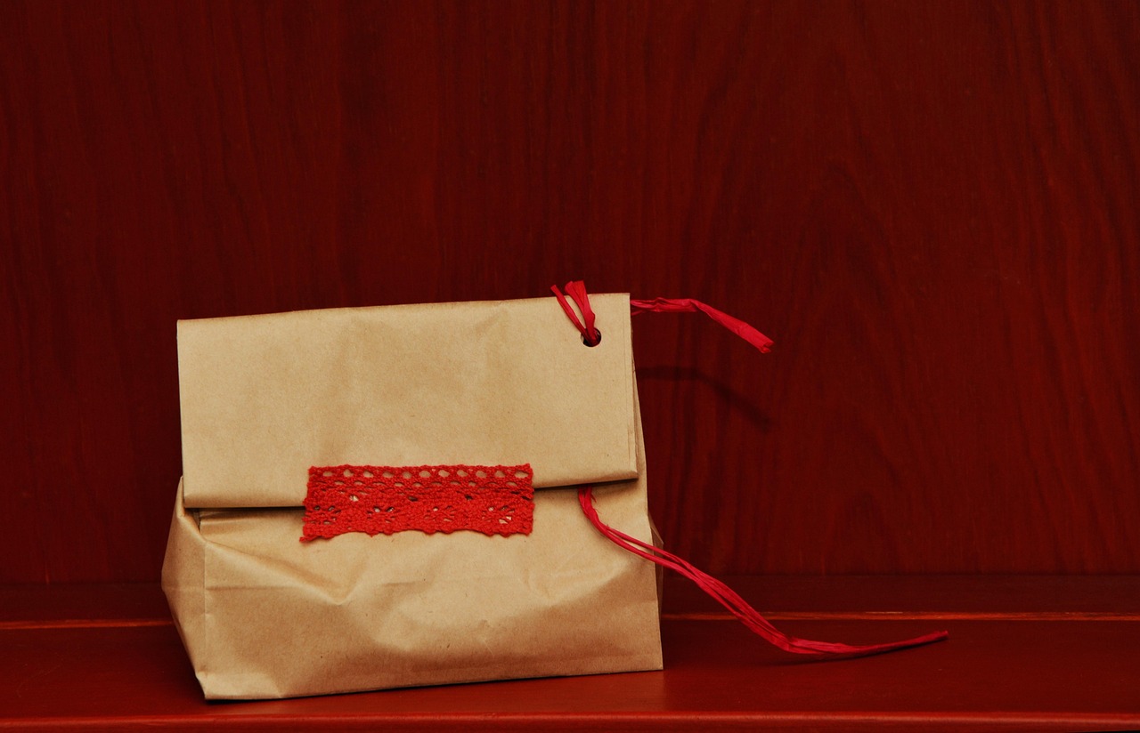 A bottle standing in a tall narrow gift bag